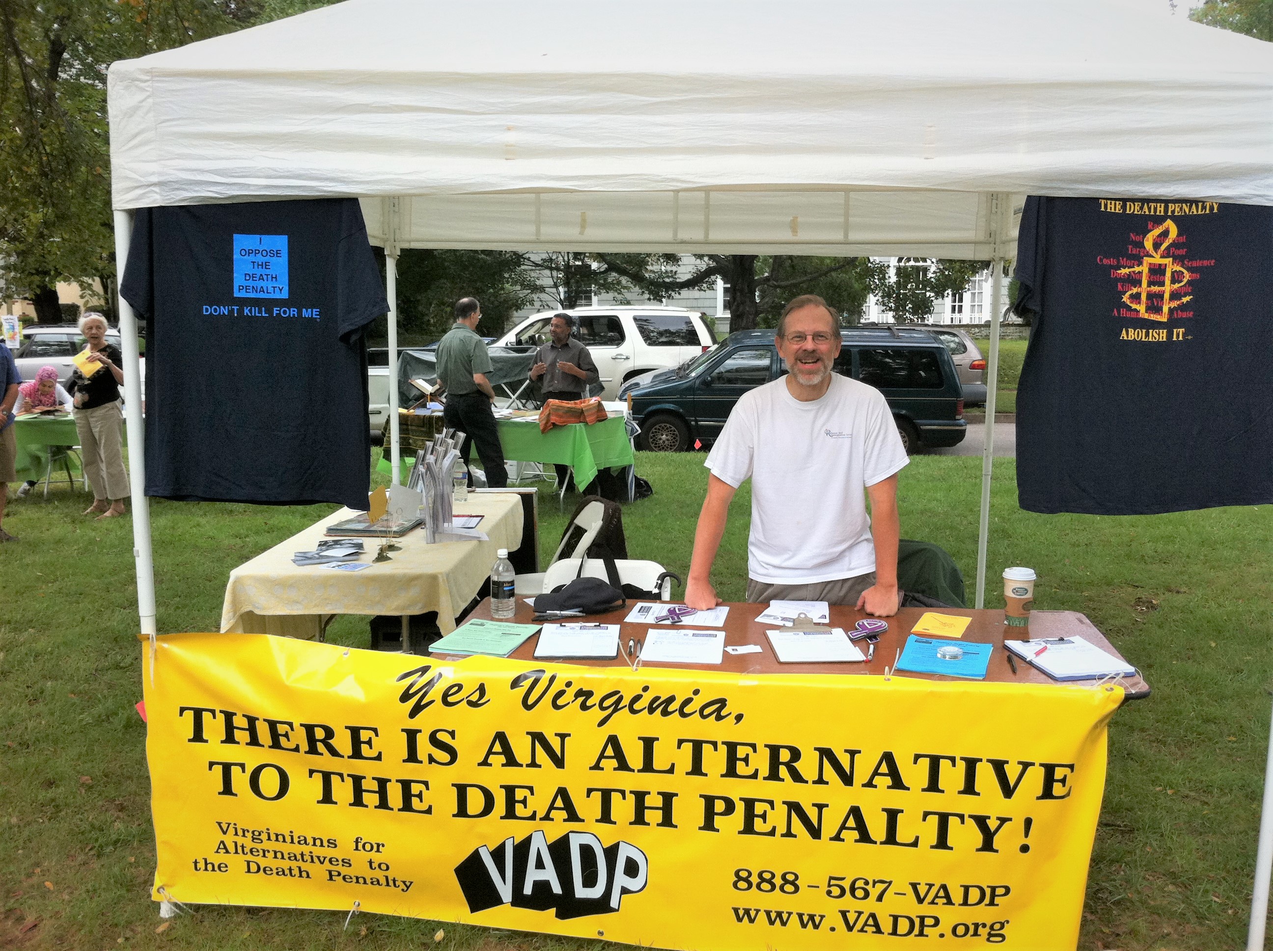 Michael Stone of the VADP stands in front of a campaign table