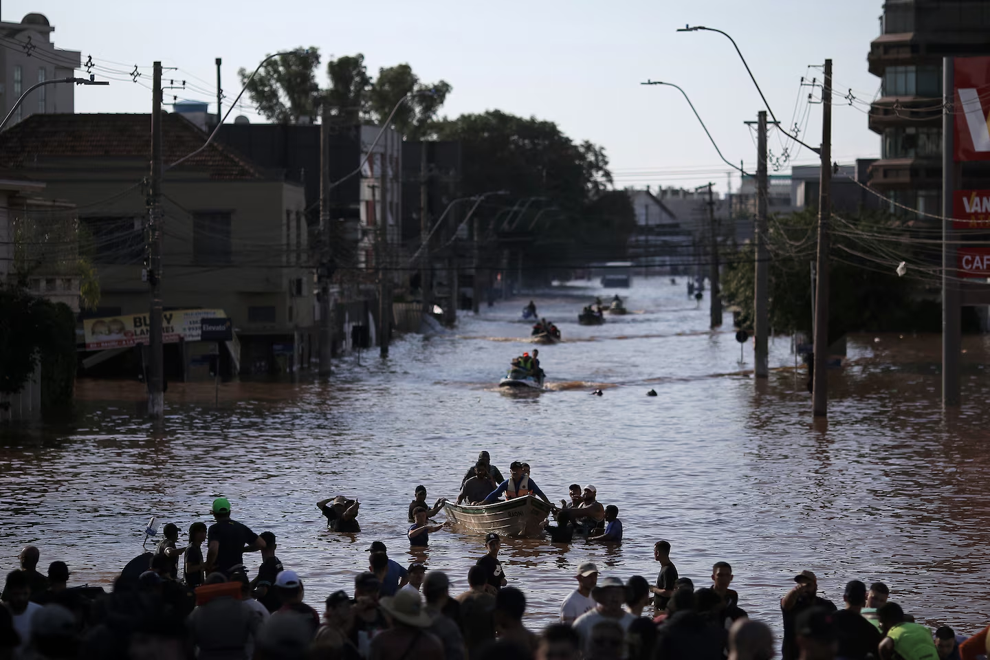 picture of people on a boat on a flooded road 