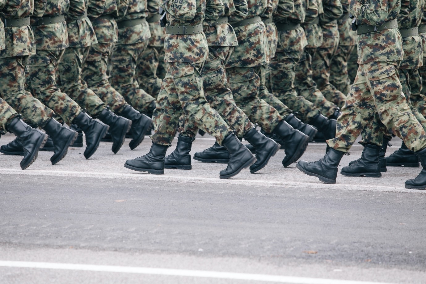 Soldiers dressed in army camouflage march in formation (Credit: Filip Andrejevic, Unsplash)