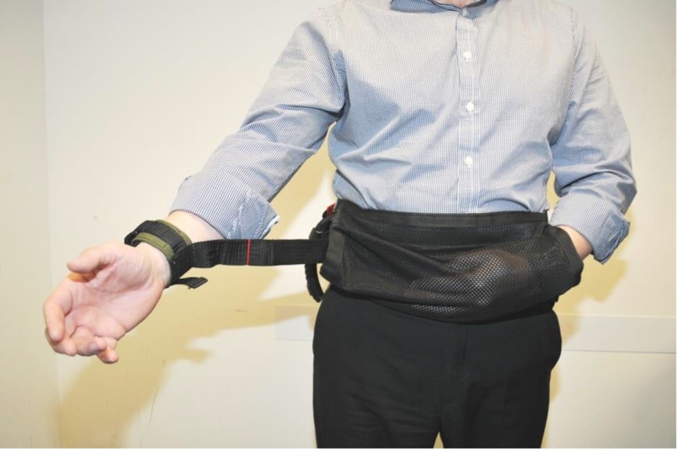 picture of a man held with the soft strap, with one hand kept and the other outside of it