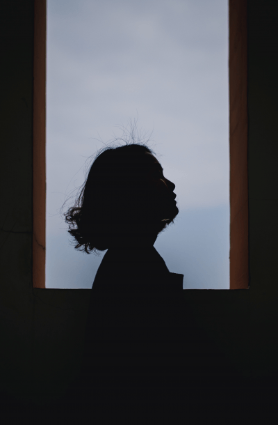 Image of a woman's head in profile against a window