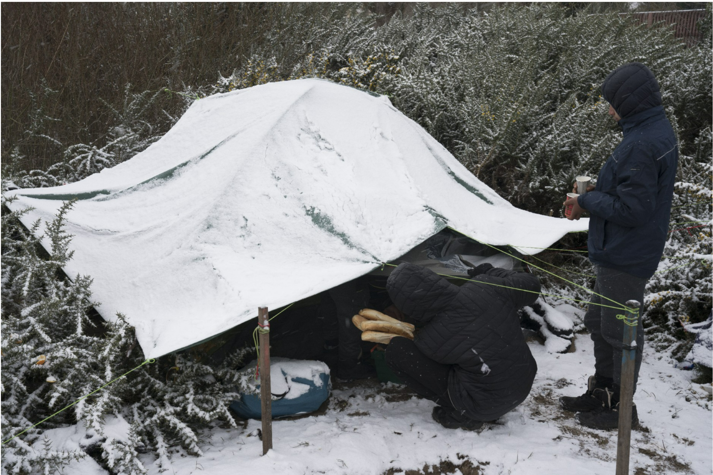 people under a tent in the snow