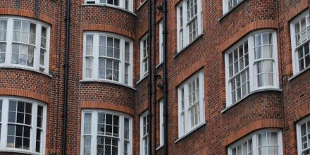 The image shows the red brick walls of a residential building