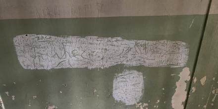 photo of writing written on the wall of a detention centre in Greece 