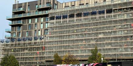 A building block under construction showing building safety nets on the facade. 