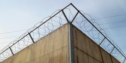 Picture of a corner of a barbed bordered fence