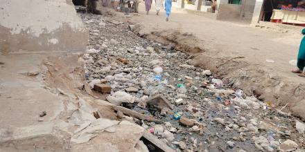 picture showing a canal filled with garbage 