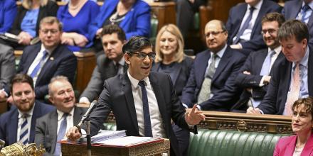 The former UK prime minister Rishi Sunak speaks during a debate in parliament, gesticulating and smiling