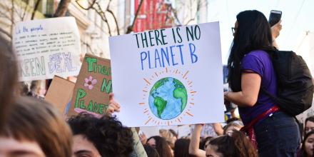 Climate protesters holding placards, including one which reads 'There Is No Planet B'.