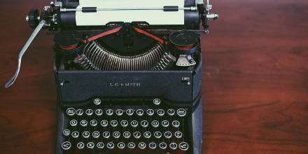 A typewriter on a desk.