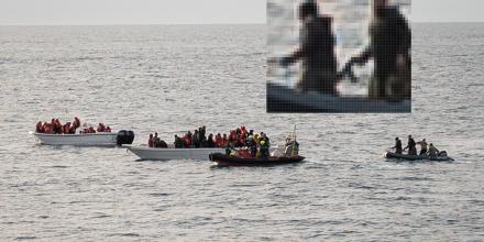 Two small white fishing boats full of people are at sea. A rhib/ dinghy boat with people in rescue gear and life jackets is positioned close to one of the white boats. Another, smaller grey boat is positioned nearby. A close up shot in frame gives a pixellated image of the men on the grey boat – one appears to be holding a weapon