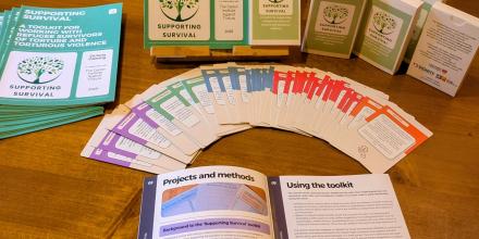 Supporting survival cards and leaflet laid out on a table