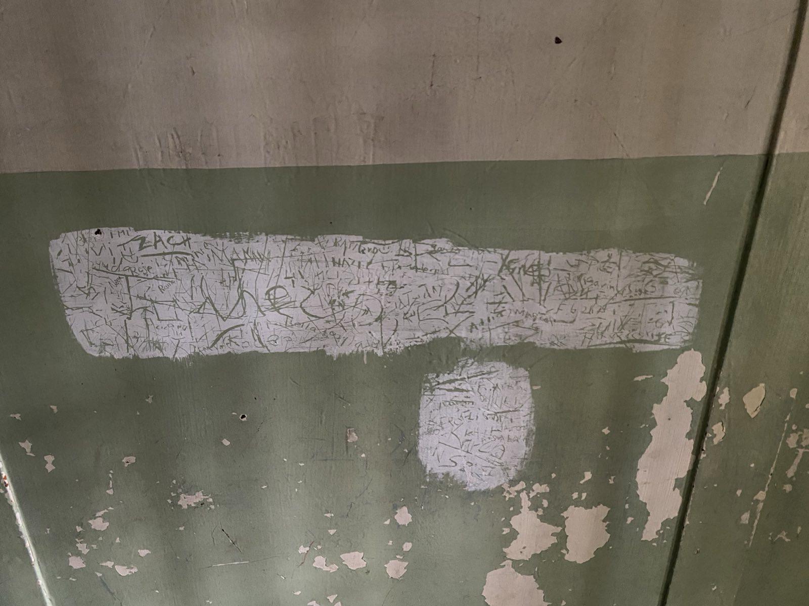 photo of writing written on the wall of a detention centre in Greece 