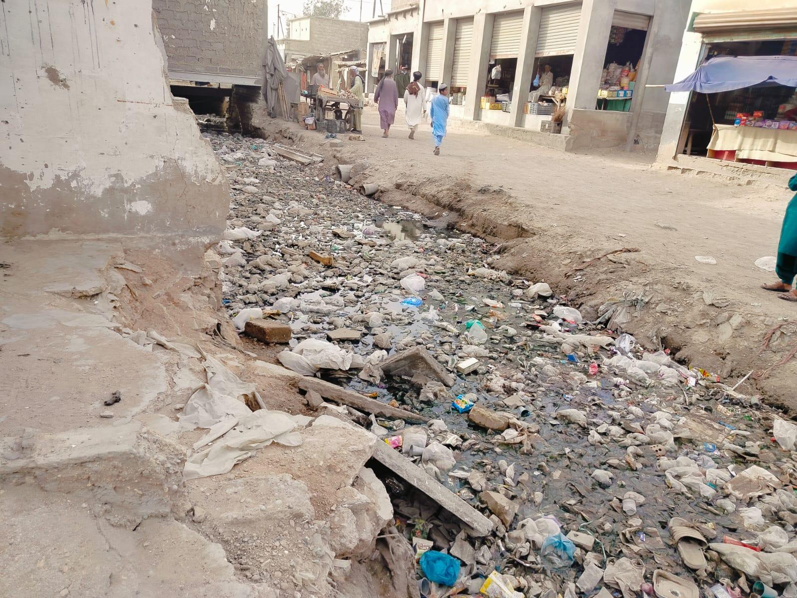 picture showing a canal filled with garbage 