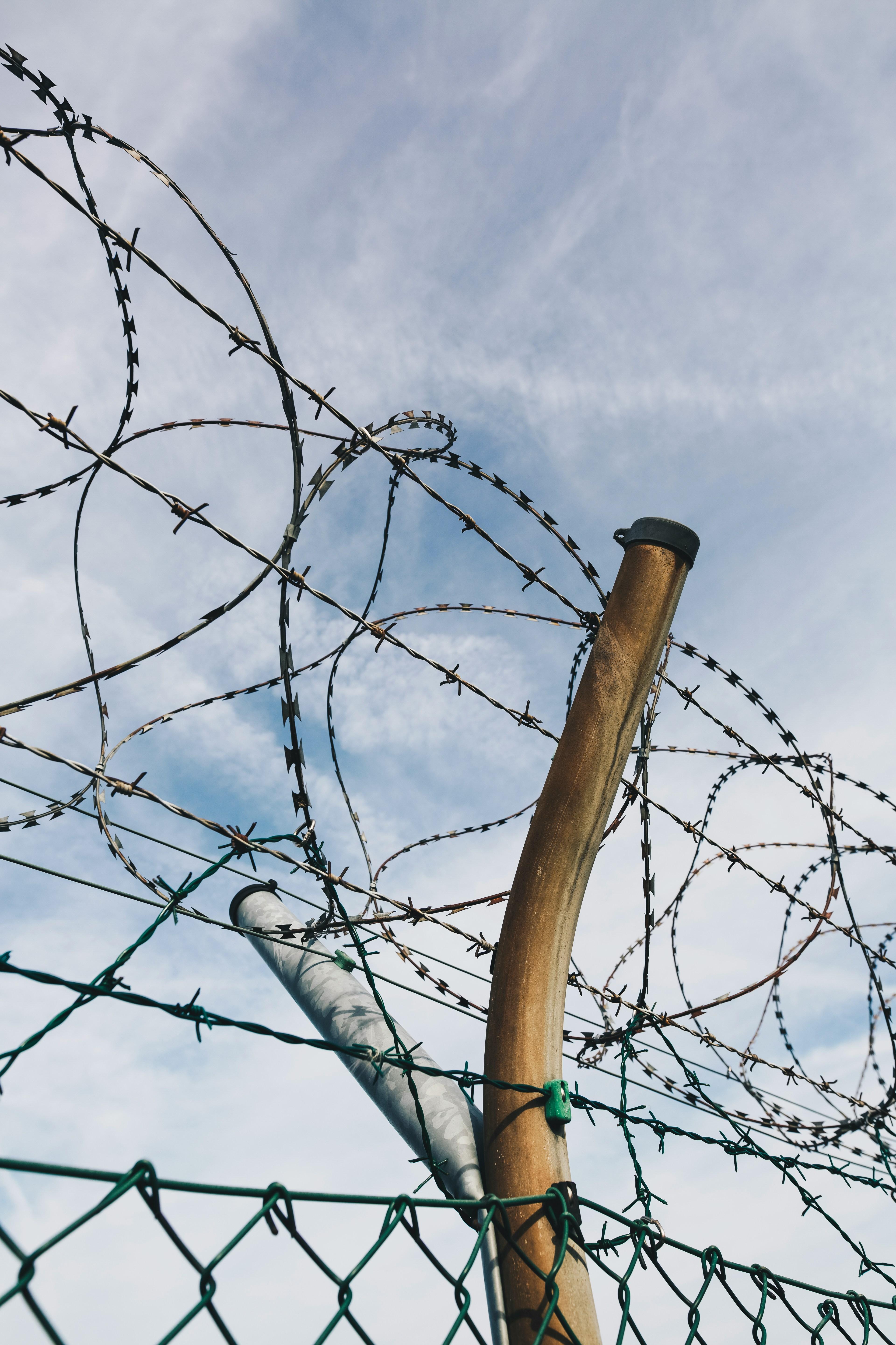 Picture of a barbed wire against a background of a blue sky
