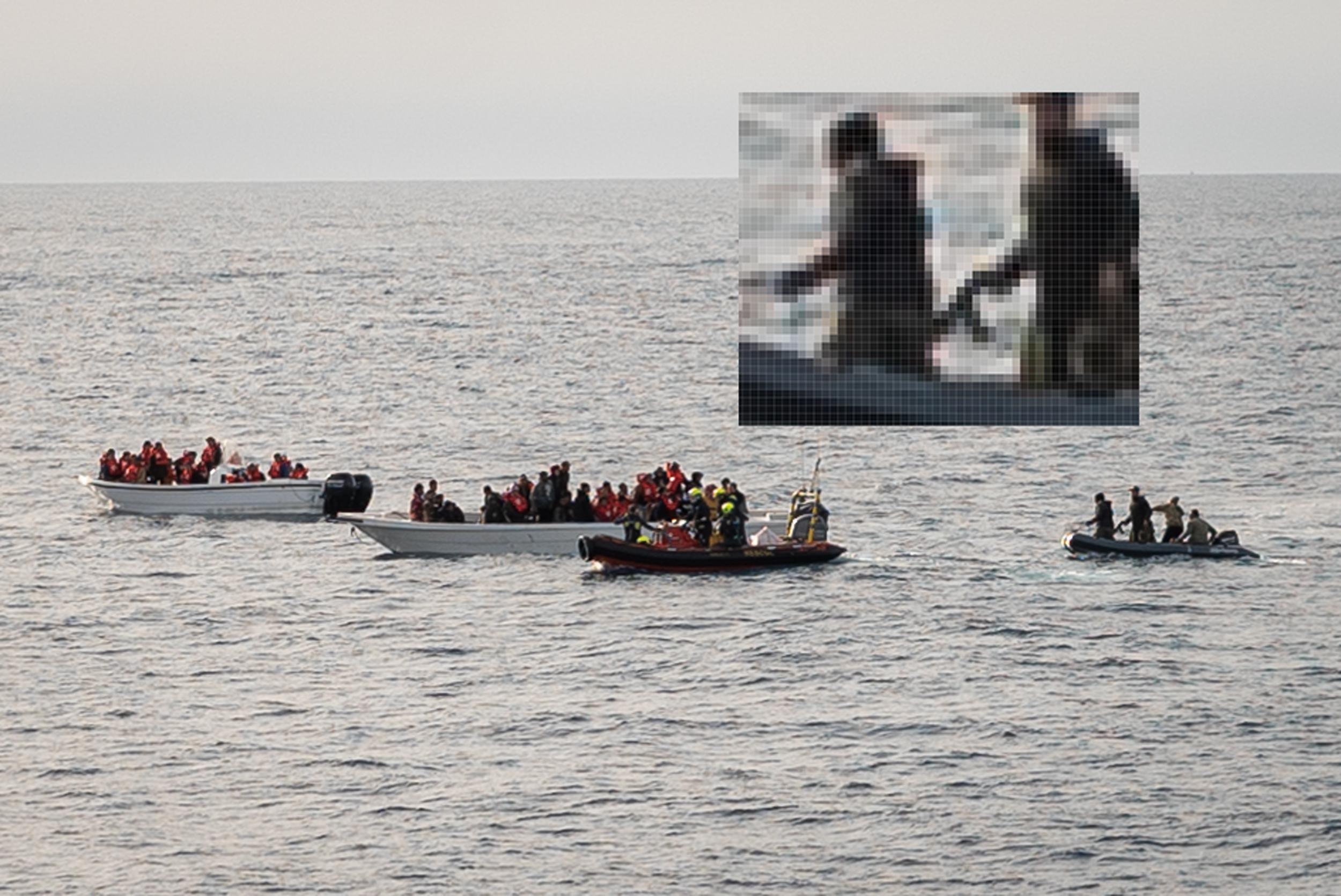 Two small white fishing boats full of people are at sea. A rhib/ dinghy boat with people in rescue gear and life jackets is positioned close to one of the white boats. Another, smaller grey boat is positioned nearby. A close up shot in frame gives a pixellated image of the men on the grey boat –&nbsp;one appears to be holding a weapon